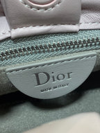 Dior logo badge on light pink bag with “Made in Italy” text
