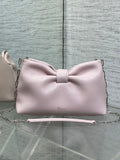 Light pink Dior bow bag with top handle and chain strap, logo on front