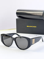 Black sunglasses with round lenses and gold 8B emblem on the temple