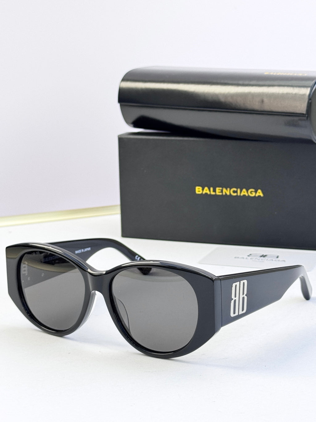 Black acetate sunglasses with round lenses and 8B logo on the side