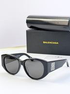 Black acetate sunglasses with round lenses and 8B logo on the side