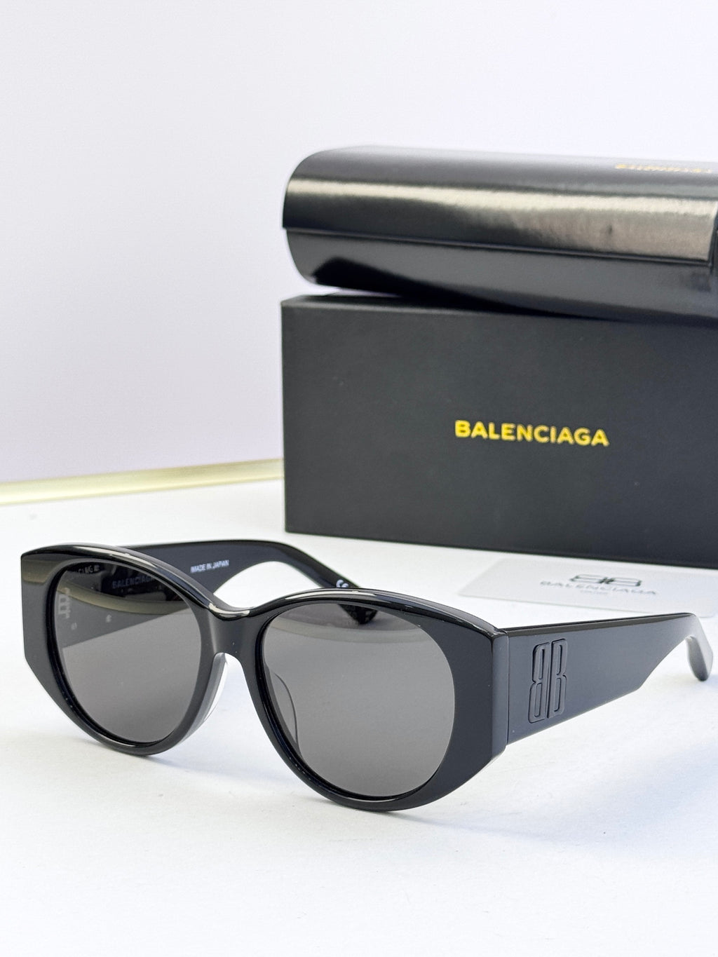 Black acetate sunglasses with round lenses and gold 8B logo at temple