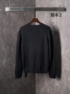Black knit crewneck sweater back view with embossed monogram motifs