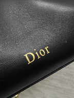 Black leather panel with gold Dior logo text