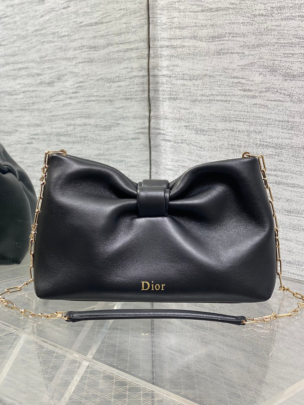 Black leather Dior bow shoulder bag with chain strap and gold Dior logo