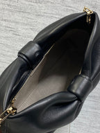 Black leather Dior bag with open top and gold clasp hardware