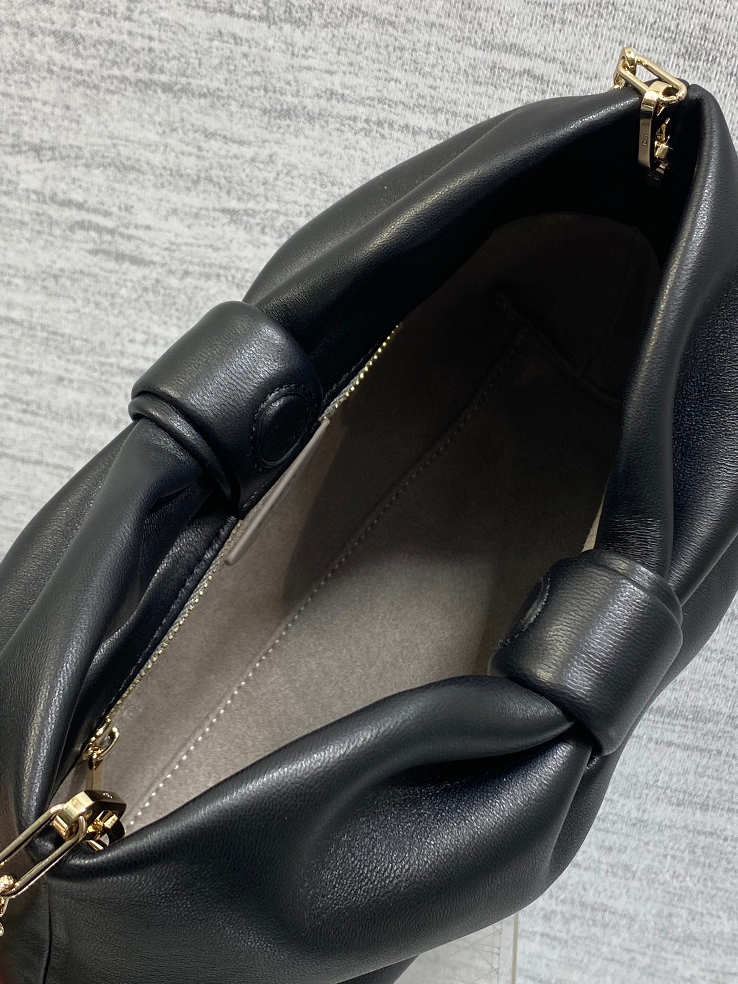 Black leather Dior bag with open top and gold clasp hardware