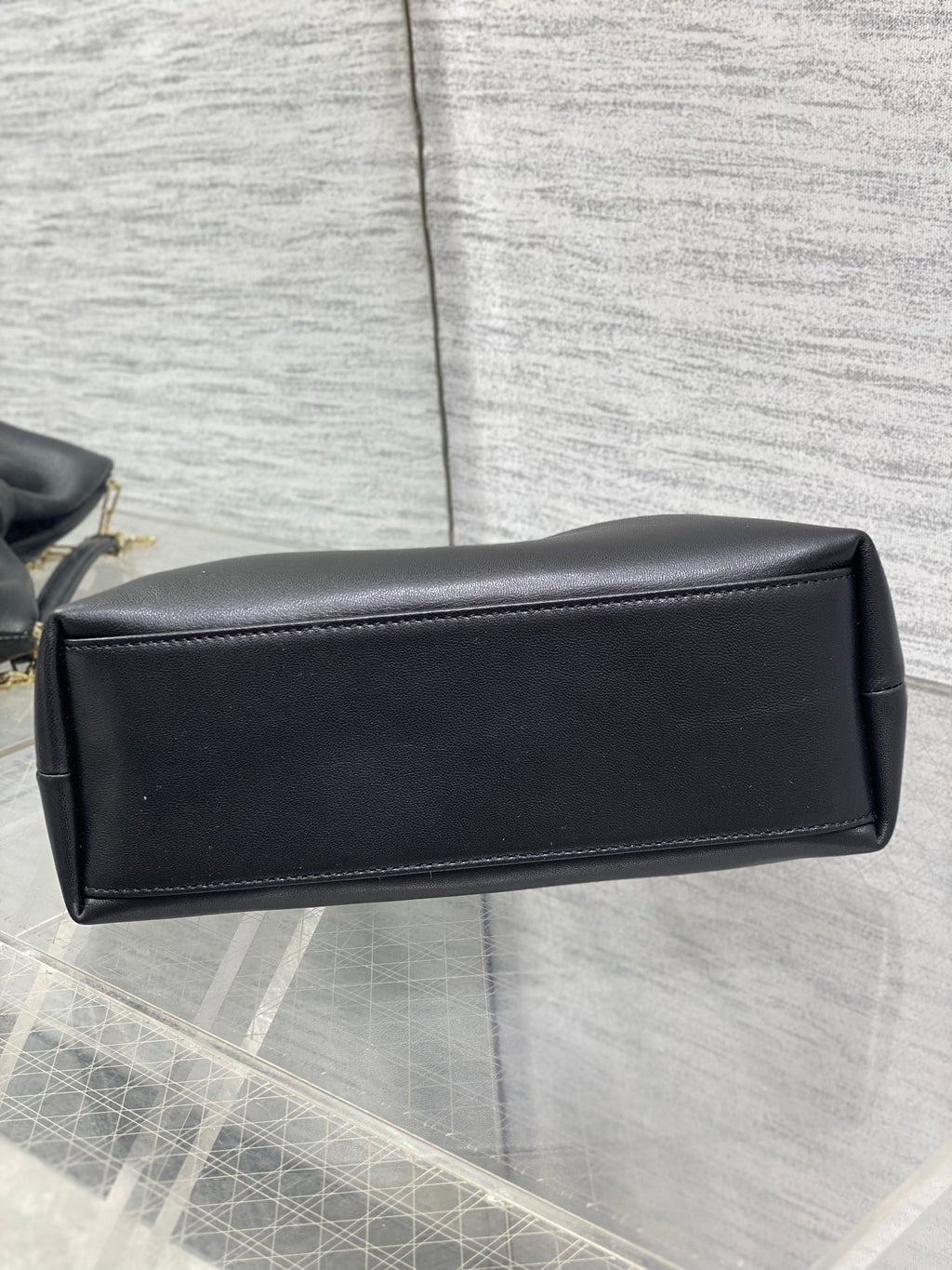 Black leather Dior bag with gold chain and rectangular back panel