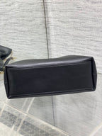 Black leather Dior bag with gold chain and rectangular back panel