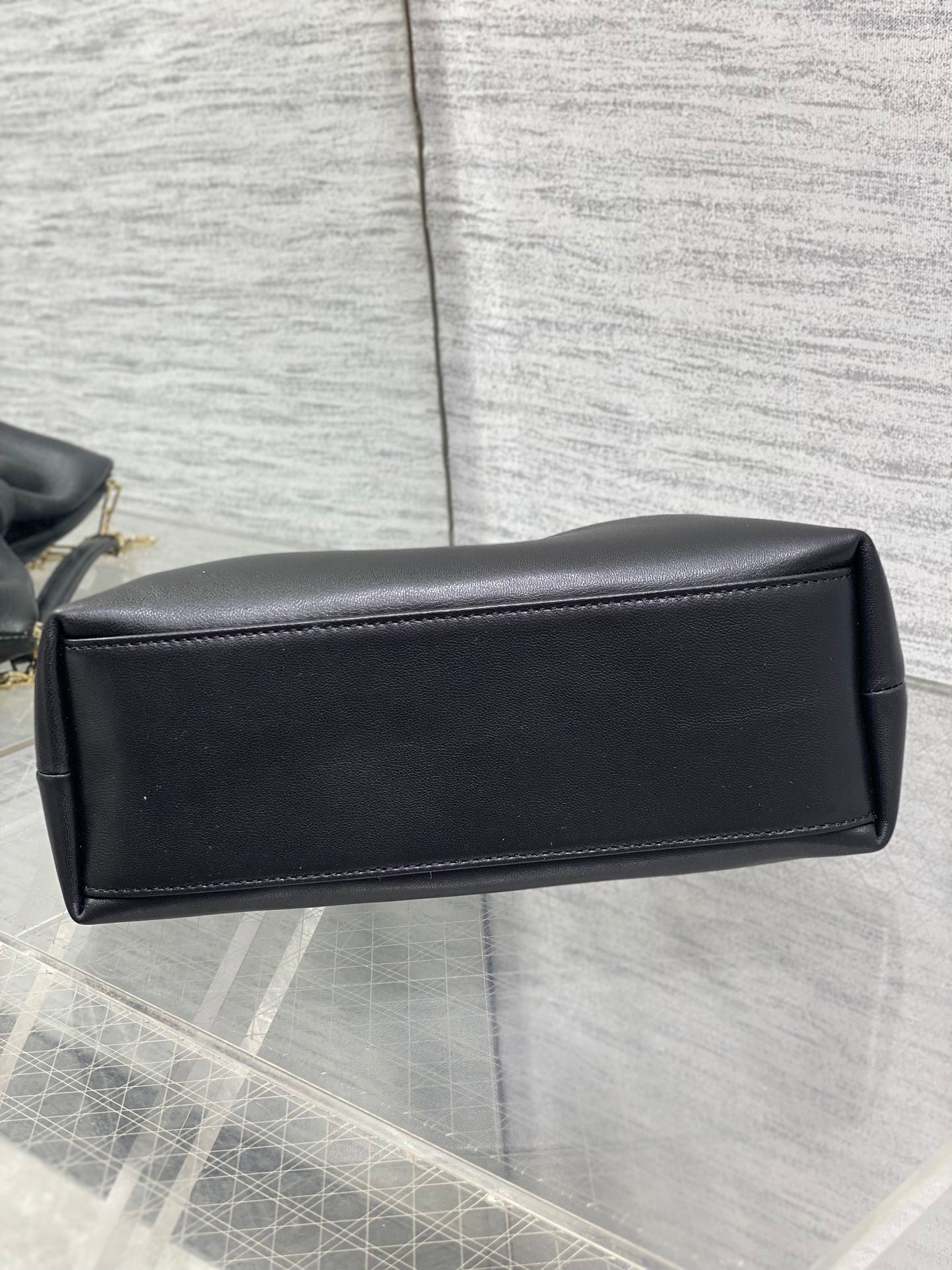 Black leather Dior bag with gold chain and rectangular back panel