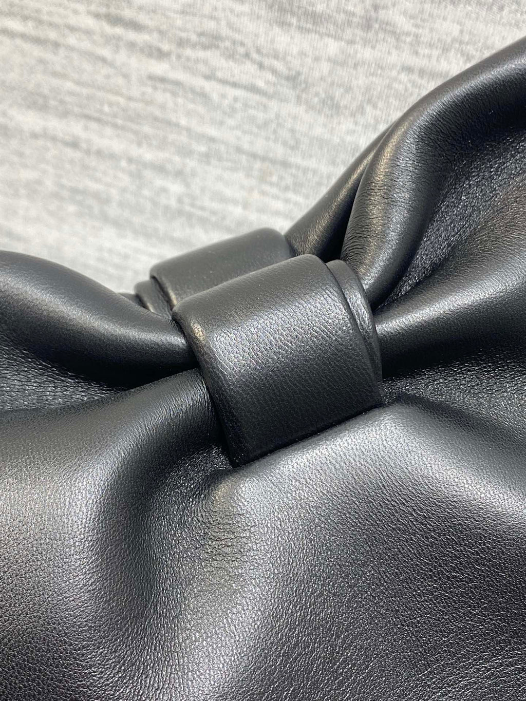 Leather bow knot detail on black Dior bag