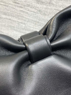 Leather bow knot detail on black Dior bag