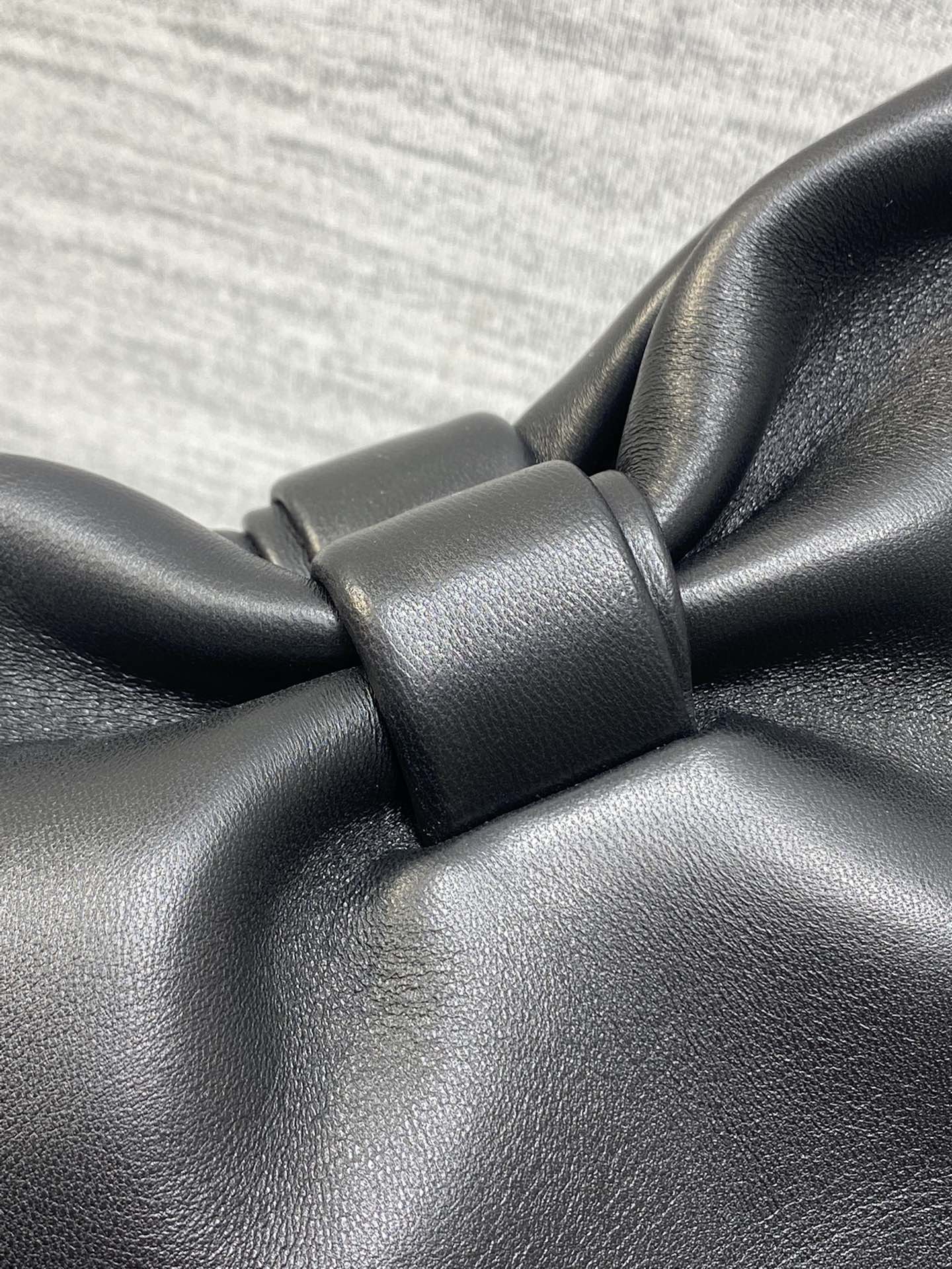 Leather bow knot detail on black Dior bag