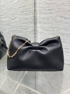 Black leather Dior bow shoulder bag with gold chain strap and Dior logo