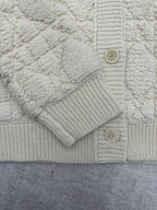 Cream knit Dior jacket front with button placket and ribbed cuffs
