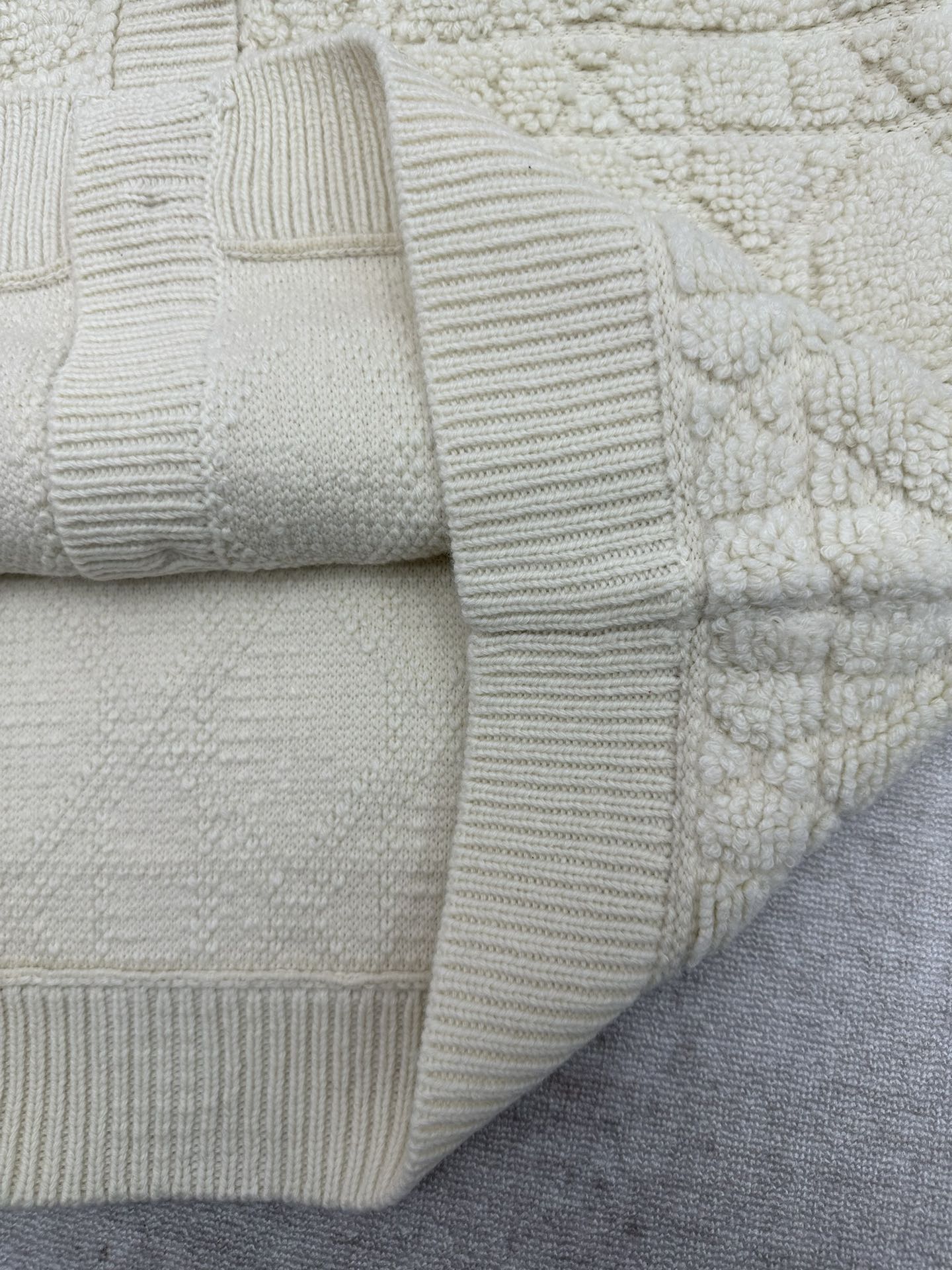 Cream knit Dior jacket sleeve cuff and textured side panel with ribbed bands
