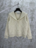 Cream knit Dior hooded jacket with quilted diamond texture and ribbed hem cuffs