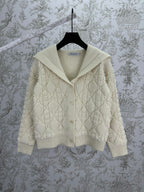 Cream knit Dior hooded jacket with quilted diamond texture and ribbed hem cuffs