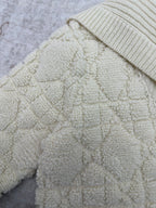 Cream teddy-textured Dior jacket sleeve and shoulder with ribbed knit trim