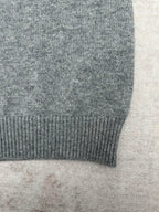 Gucci gray knit cardigan hem close-up with ribbed trim along the bottom edge