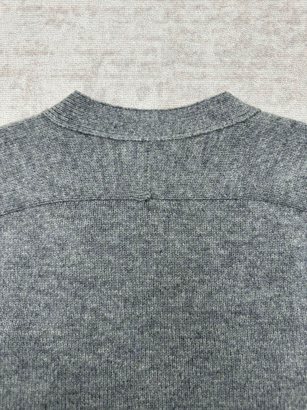 Gucci gray knit cardigan back neckline close-up with ribbed collar and seam detail