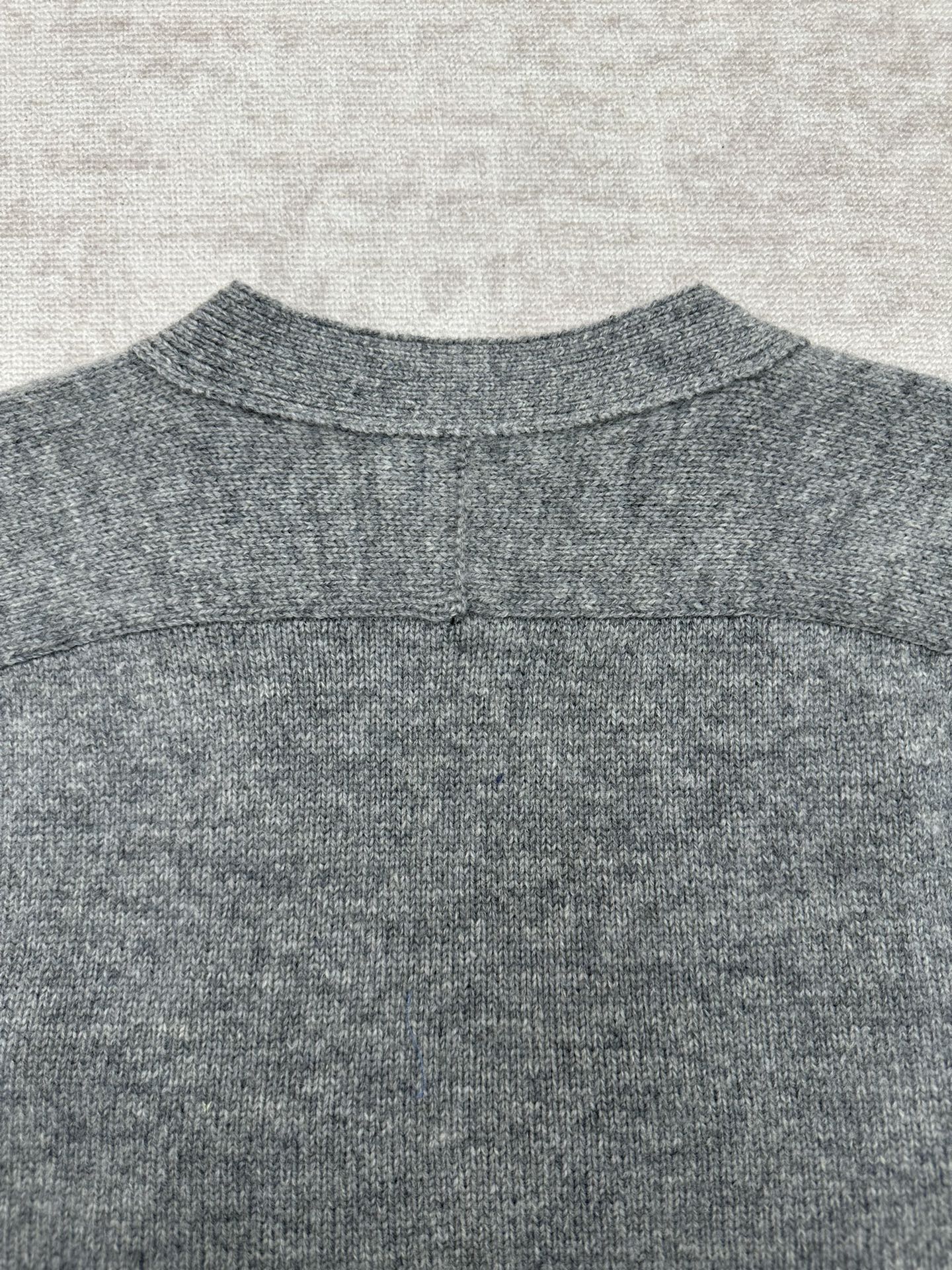 Gucci gray knit cardigan back neckline close-up with ribbed collar and seam detail