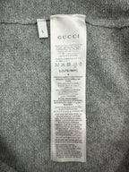 Gucci clothing care and material tag on gray knit cardigan