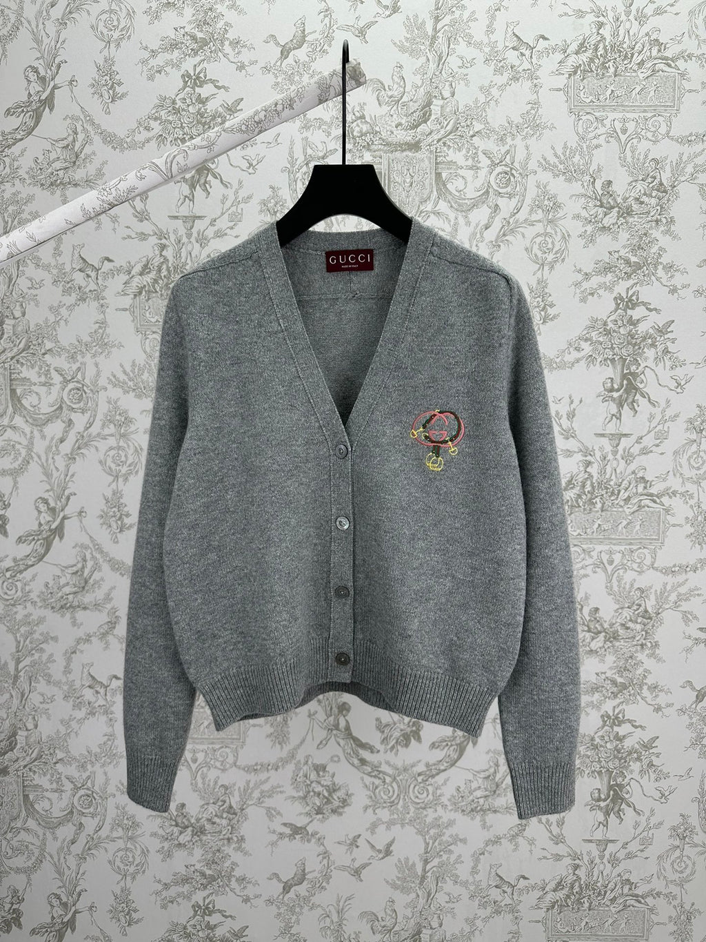 Gucci gray knit cardigan with V-neck, button front, and colorful crest logo on chest
