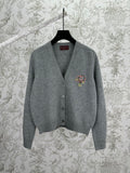Gucci gray knit cardigan with V-neck, button front, and colorful crest logo on chest