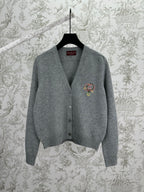 Gucci gray knit cardigan with V-neck, button front, and colorful crest logo on chest
