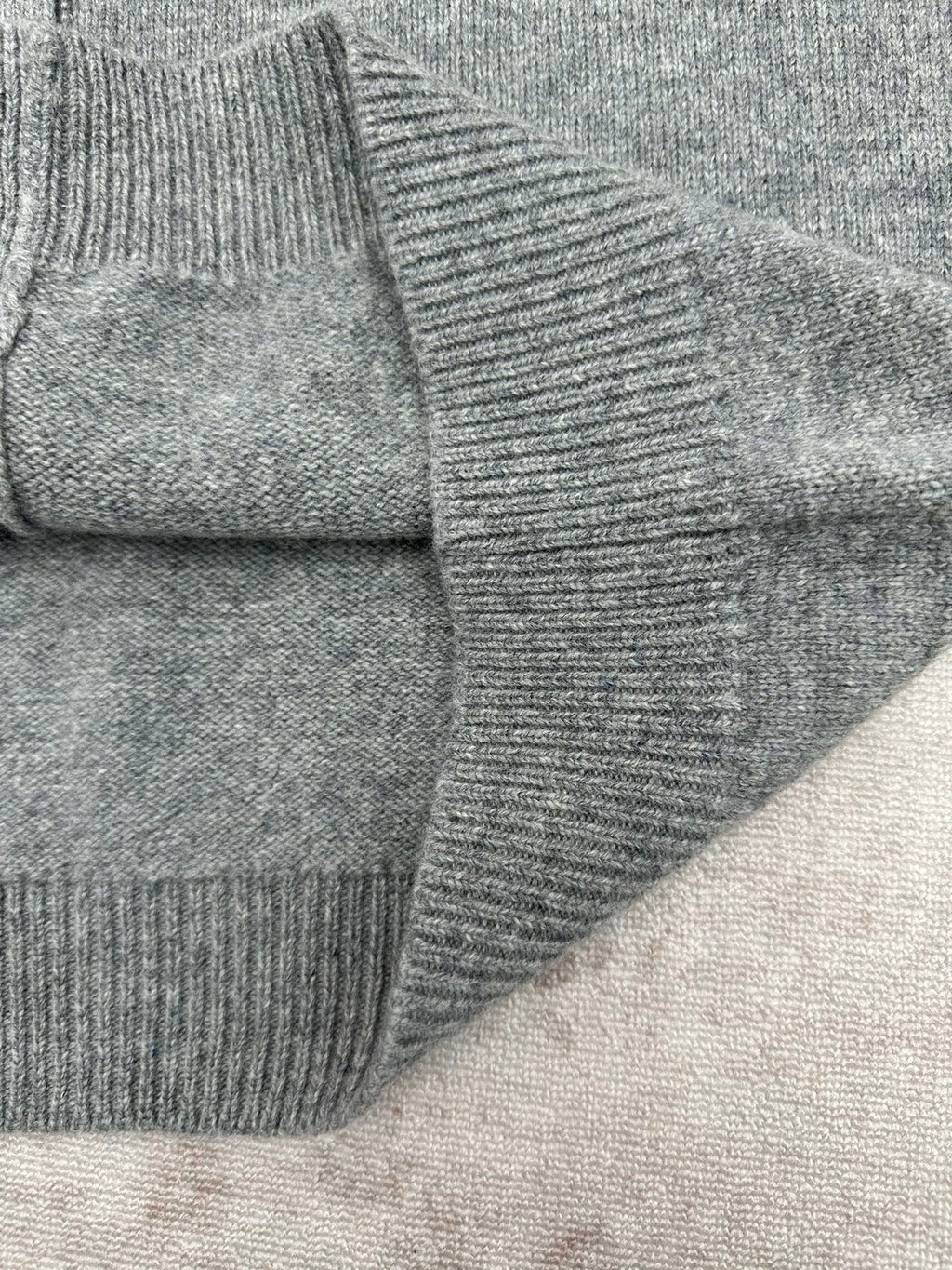 Gucci gray knit cardigan sleeve and shoulder seam close-up with ribbed cuff