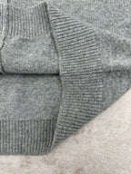 Gucci gray knit cardigan sleeve and shoulder seam close-up with ribbed cuff