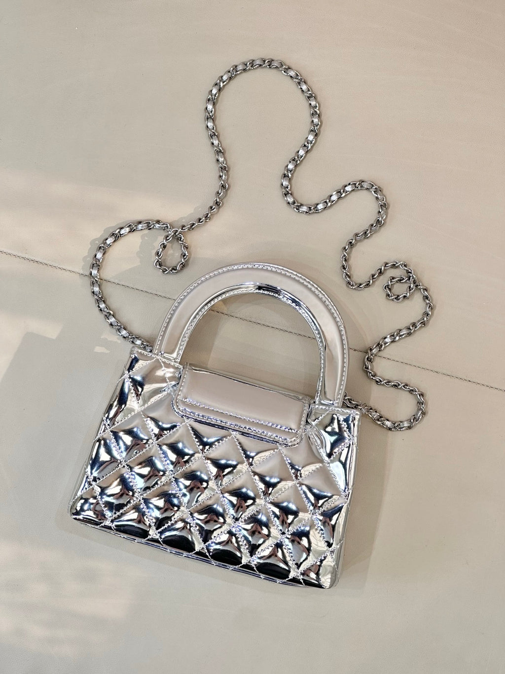 Chanel silver quilted mini bag with chain shoulder strap, front angle