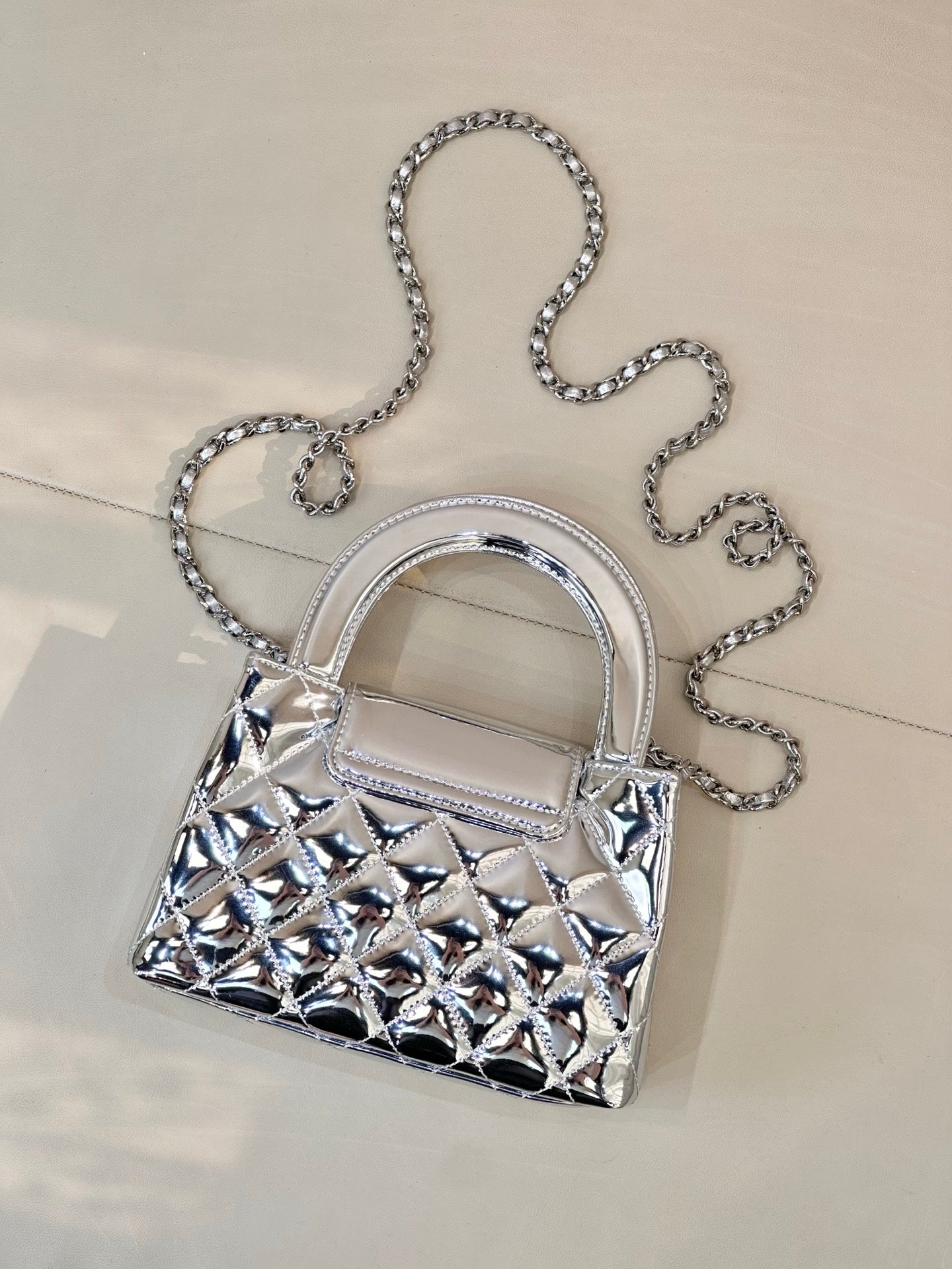 Chanel silver quilted mini bag with chain shoulder strap, front angle