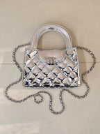 Chanel silver quilted mini bag with curved top handles and chain crossbody strap