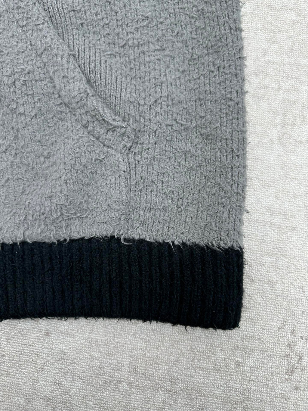 Balenciaga knit hem with dark navy ribbed band and gray textured fabric