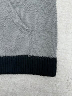 Balenciaga knit hem with dark navy ribbed band and gray textured fabric