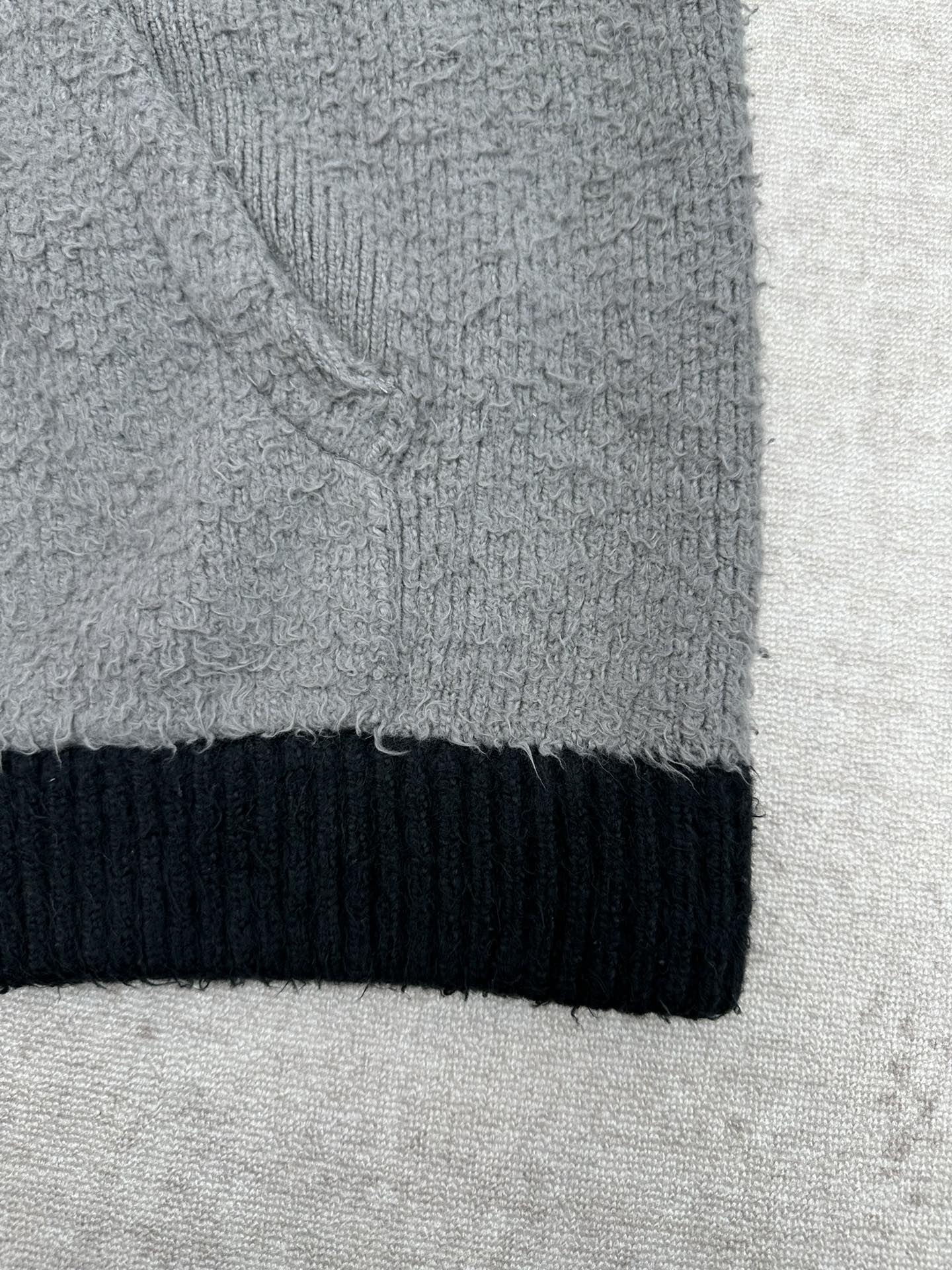 Balenciaga knit hem with dark navy ribbed band and gray textured fabric