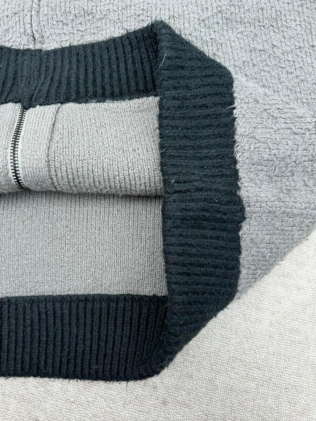Balenciaga knit zip hoodie close-up with ribbed cuff and dark navy hood trim