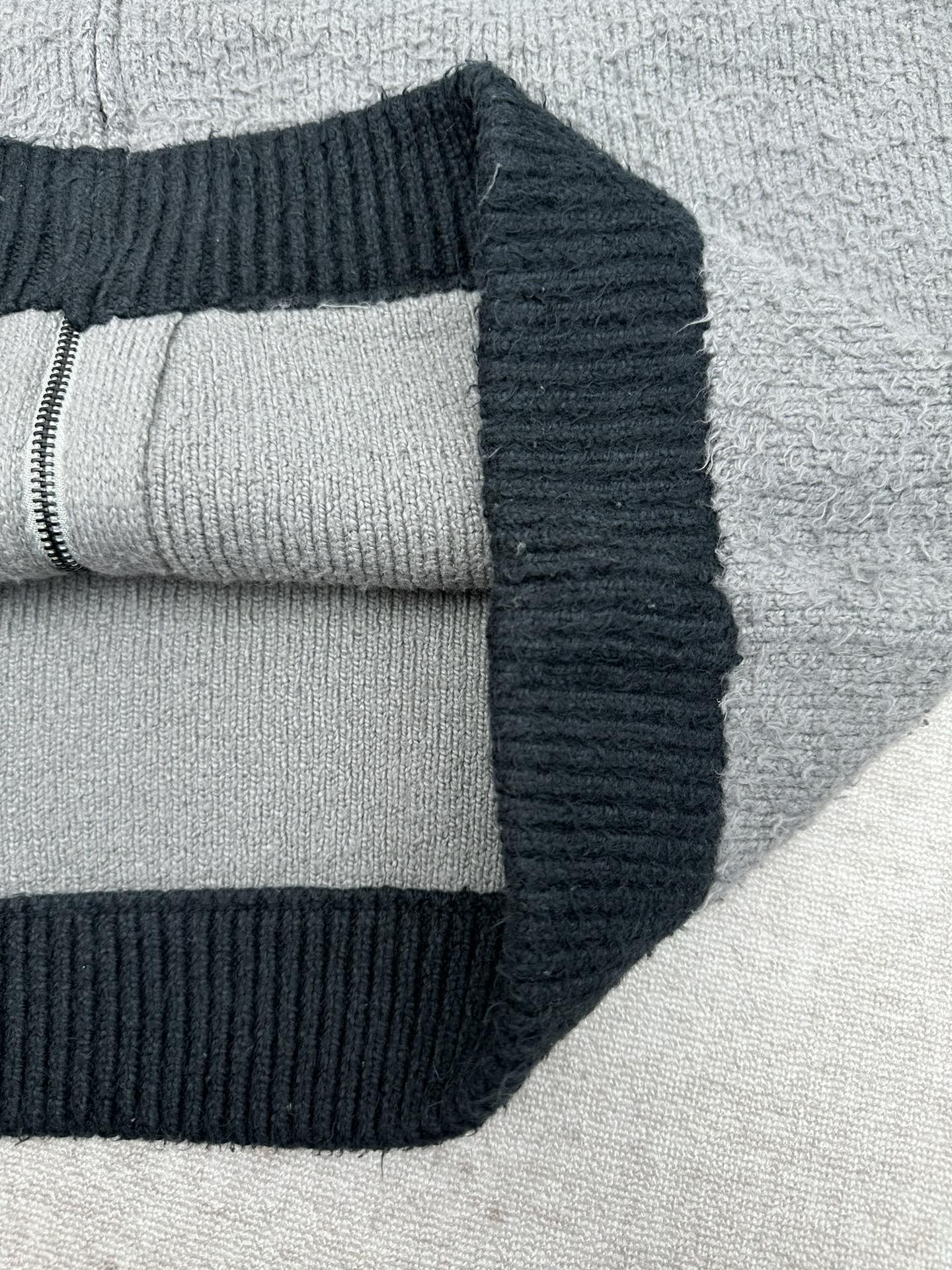 Balenciaga knit zip hoodie close-up with ribbed cuff and dark navy hood trim