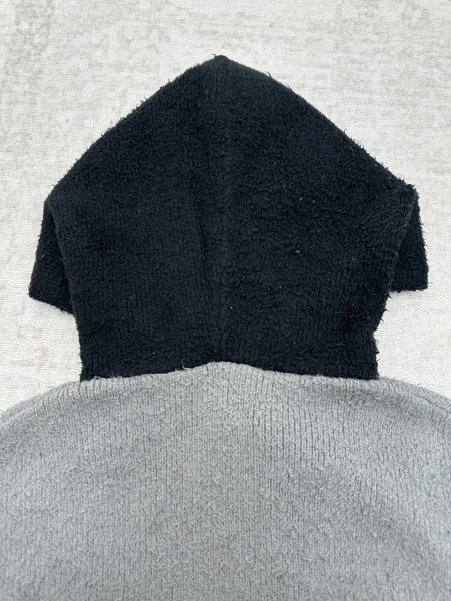 Balenciaga knit hooded zip sweater with dark navy top and gray lower body
