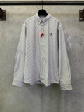 Striped button-up shirt with long sleeves, front buttons, and small chest logo embroidery
