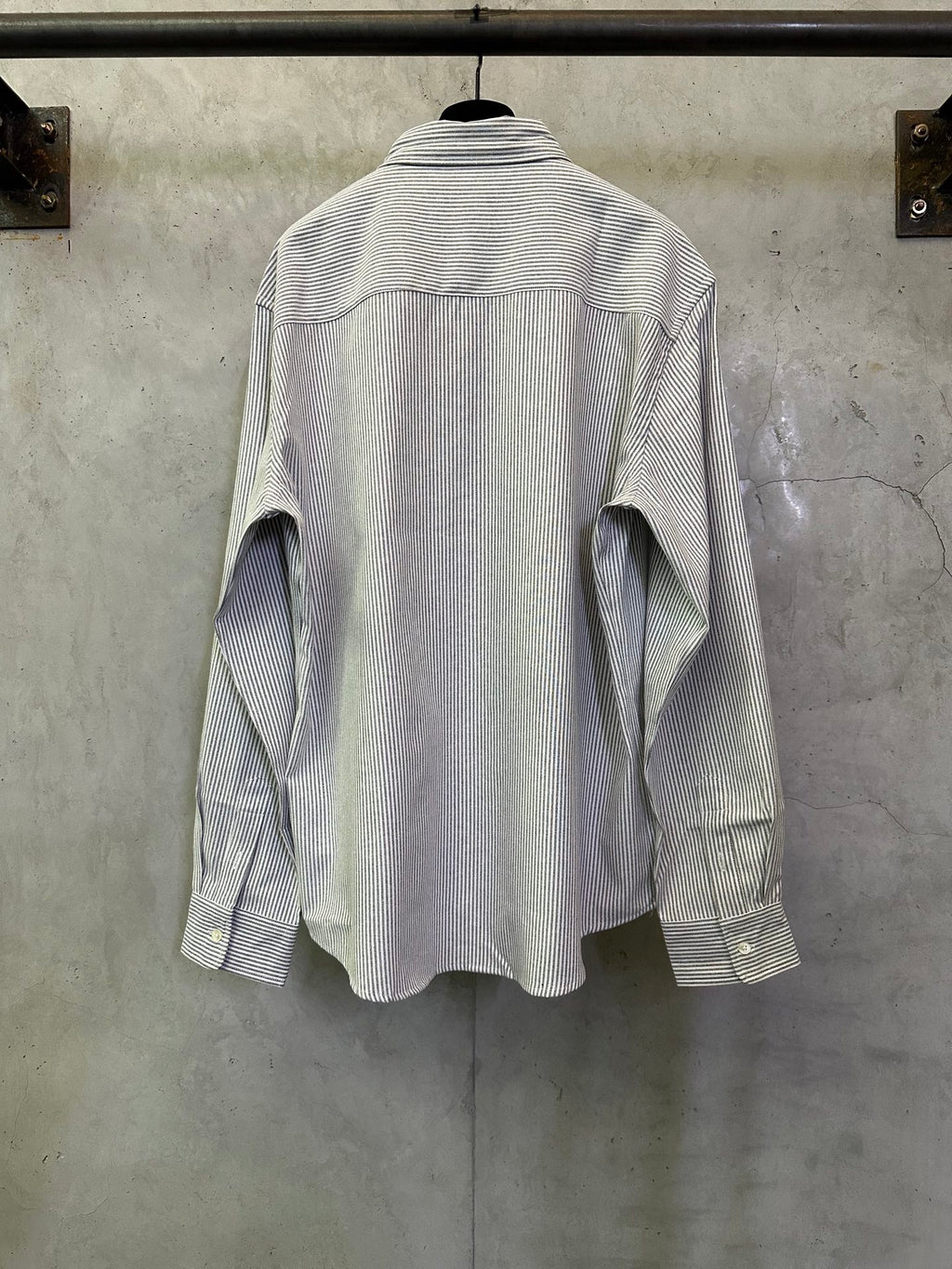 Striped long-sleeve button-up shirt shown from the back with collar and button placket