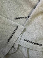 Heather gray T-shirt sleeves with Chrome Hearts logo prints on cuffs