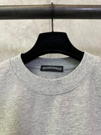 Heather gray crewneck T-shirt neckline with brand label tag inside collar