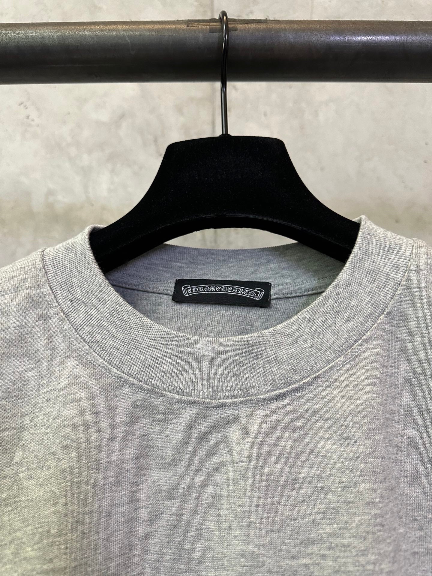 Heather gray crewneck T-shirt neckline with brand label tag inside collar