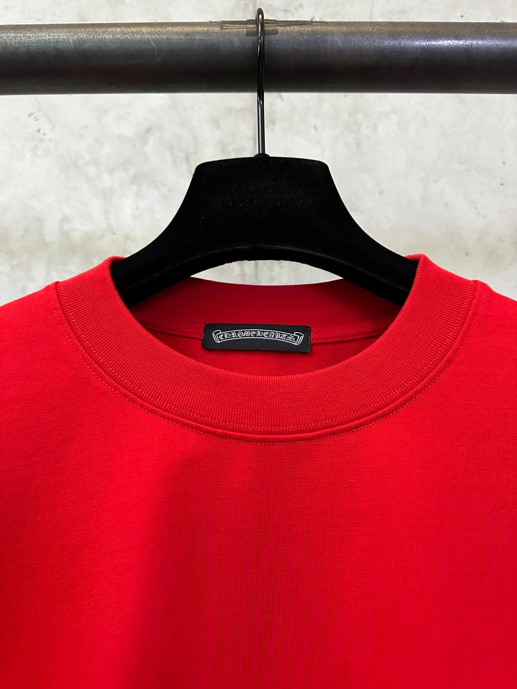 Red crewneck T-shirt neckline with brand tag on the inside collar.