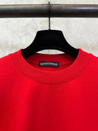 Red crewneck T-shirt neckline with brand tag on the inside collar.