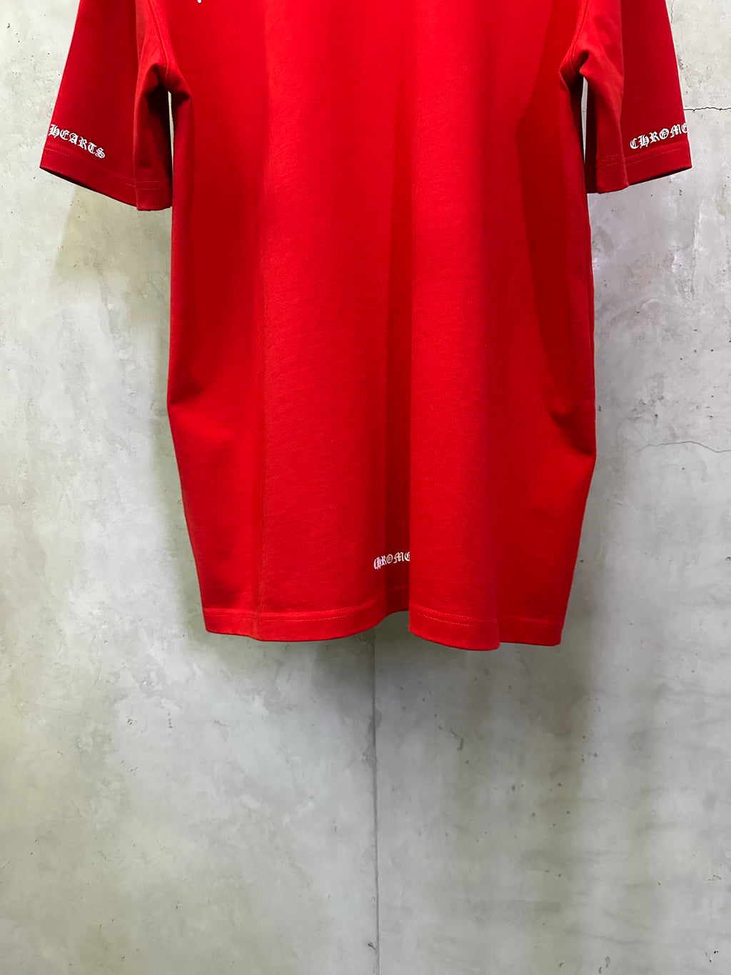 Red short-sleeve T-shirt back view with sleeve cuffs and curved hem.