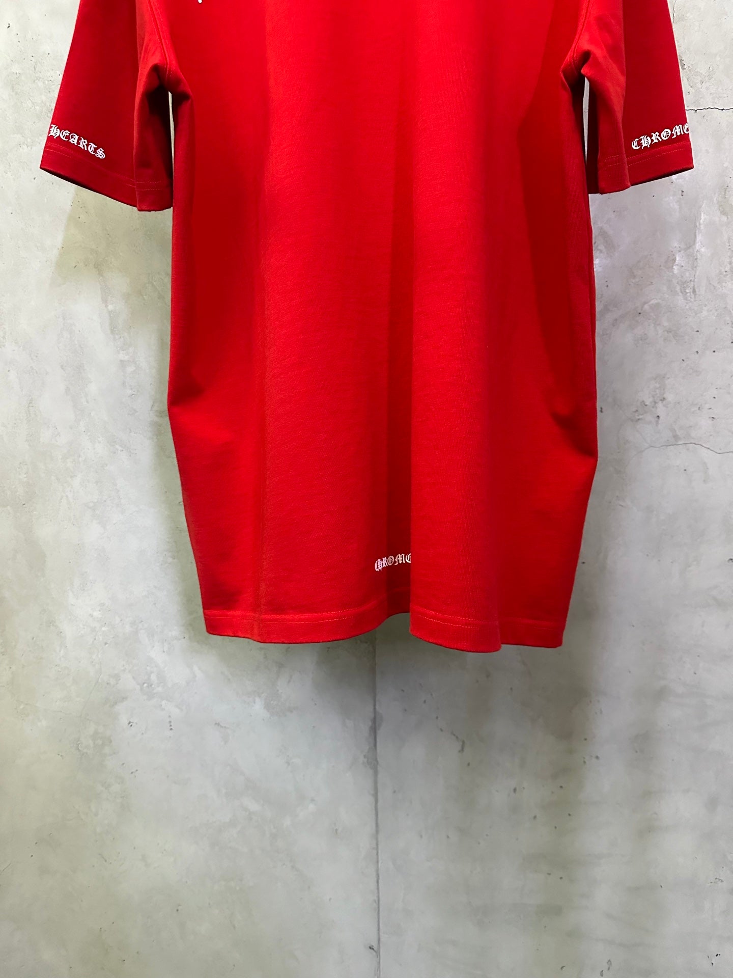 Red short-sleeve T-shirt back view with sleeve cuffs and curved hem.